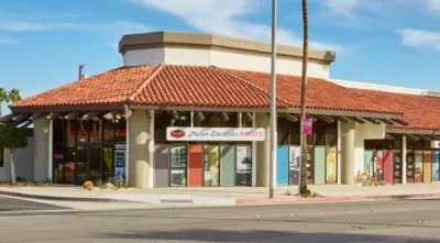 A building with a store on the corner of a street