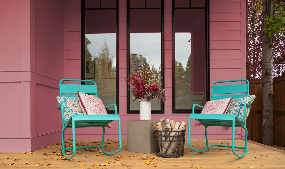 terra rosa A pink flower on a chair in front of a house