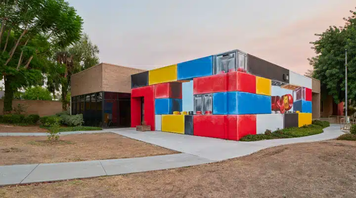 A colorful train sits on the grass