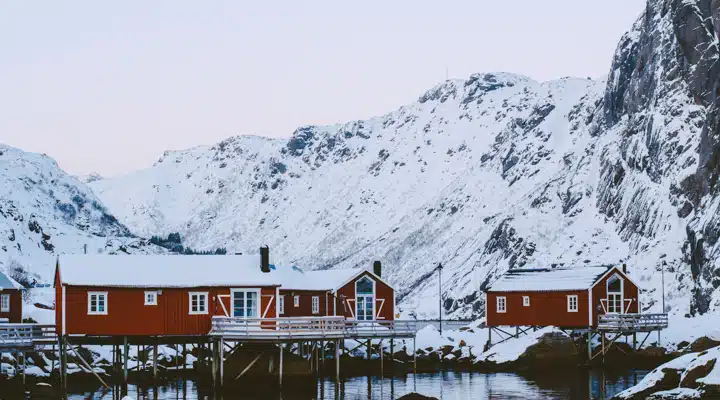 A sign above a snow covered mountain