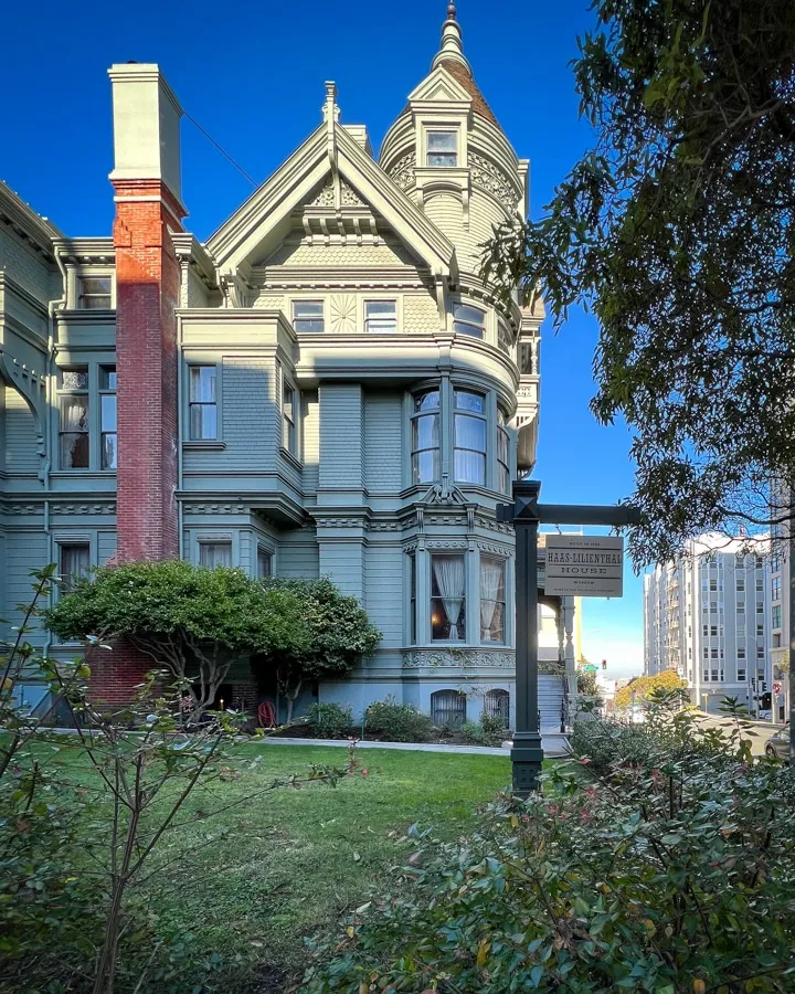 A small clock tower in front of a building