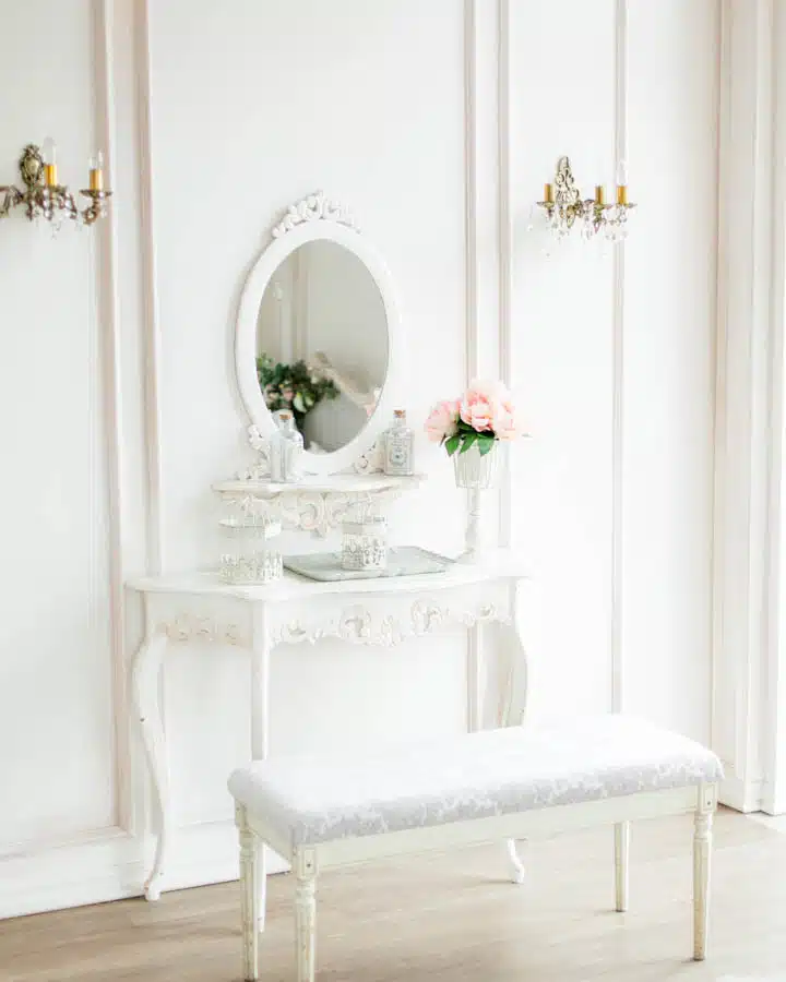 A room filled with furniture and vase of flowers on a table