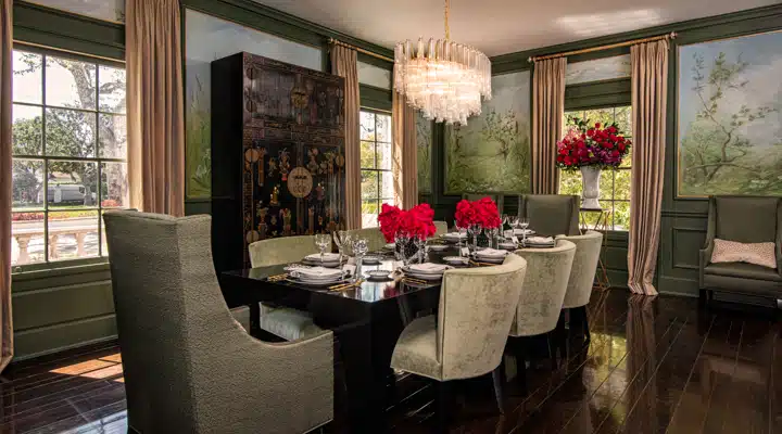 A living room filled with furniture and vase of flowers on a table