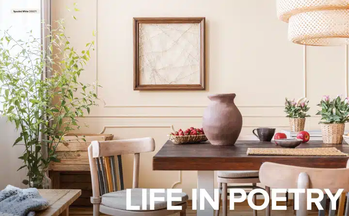 A room filled with furniture and vase of flowers on a table