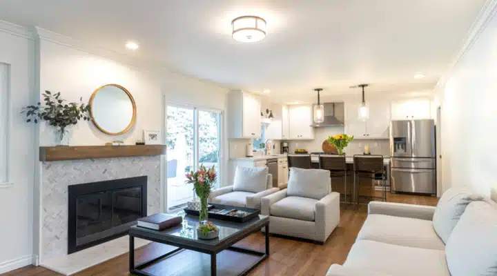 A view of a living room filled with furniture and a fire place