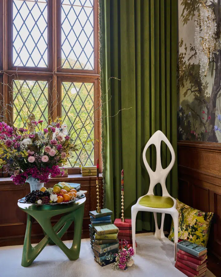 A room filled with furniture and vase of flowers on a table