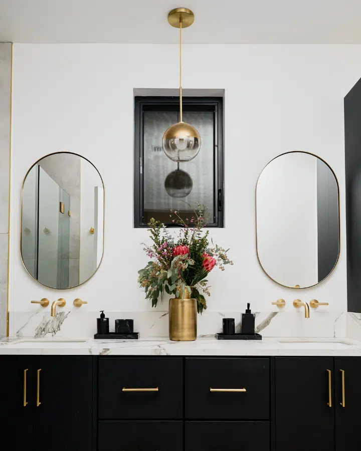 A kitchen with a sink and a mirror