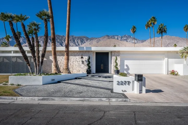 A palm tree in front of a building