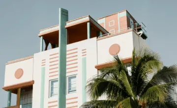 A group of palm trees on the side of a building